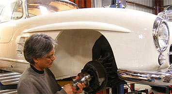 Professional Restoration Mechanic working on a Mercedes-Benz Gullwing in our shop
