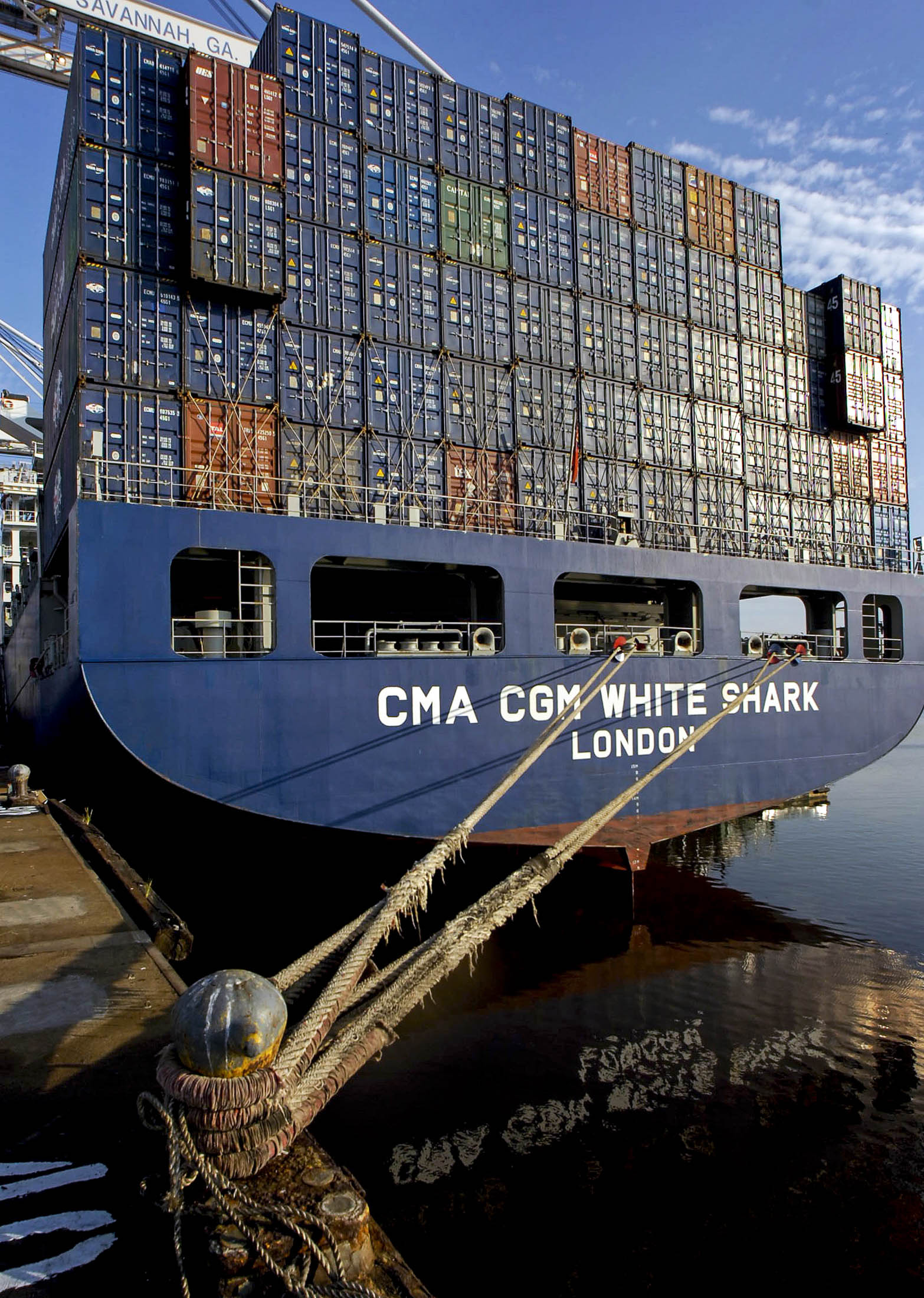 The container ship CMA CGM White Shark is tied up at the Georgia Port Authority's Garden City terminal waiting to be unloaded. Shipping between major ports is less expensive than door-to-door or obscure-city delivery. Photographer: Stephen Morton/Bloomberg