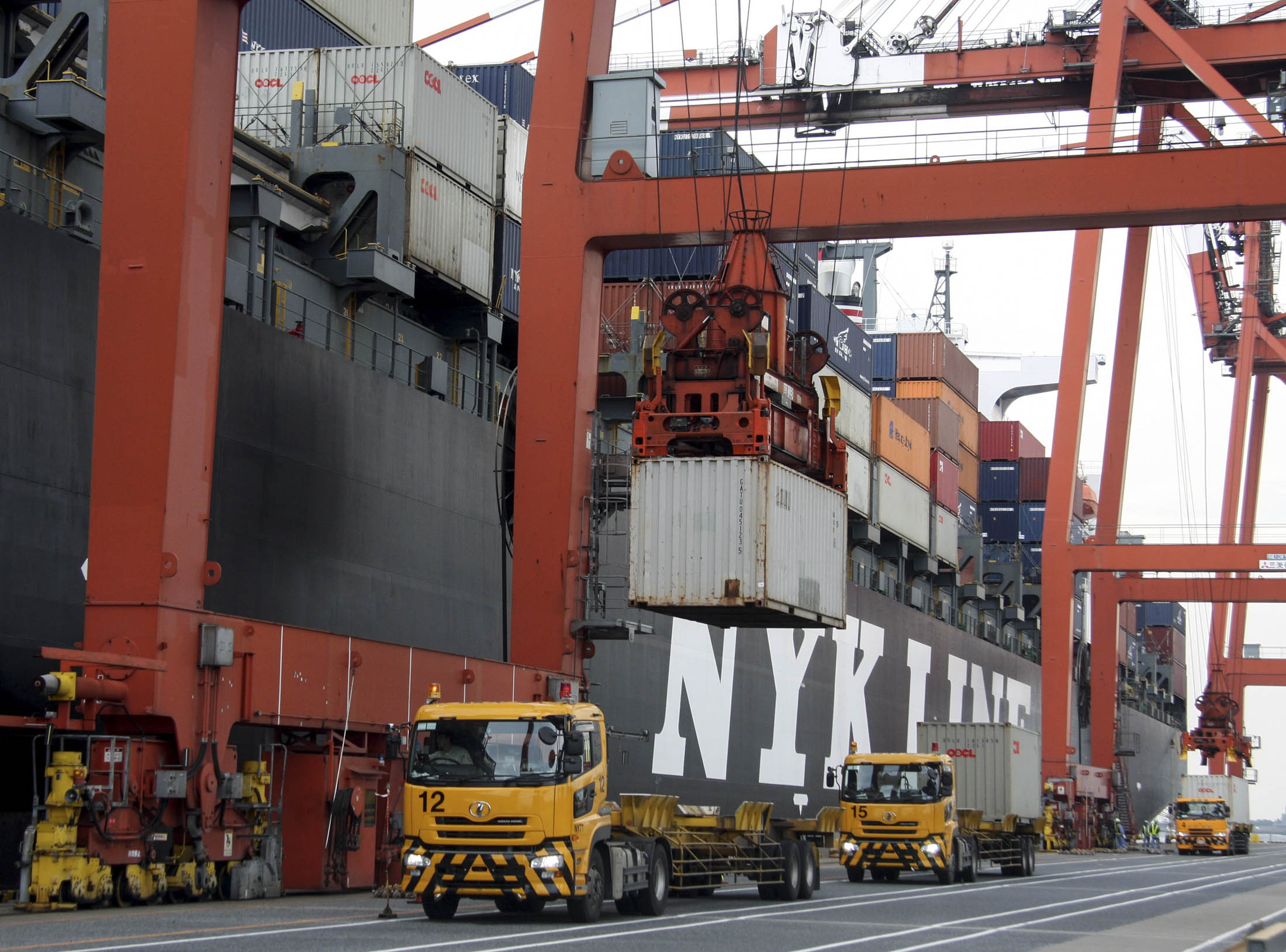 A container is unloaded from a truck onto a ship at a container terminal in Tokyo, Japan, on Friday, Sep 26, 2008. Photographer: Haruyoshi Yamaguchi/Bloomberg News